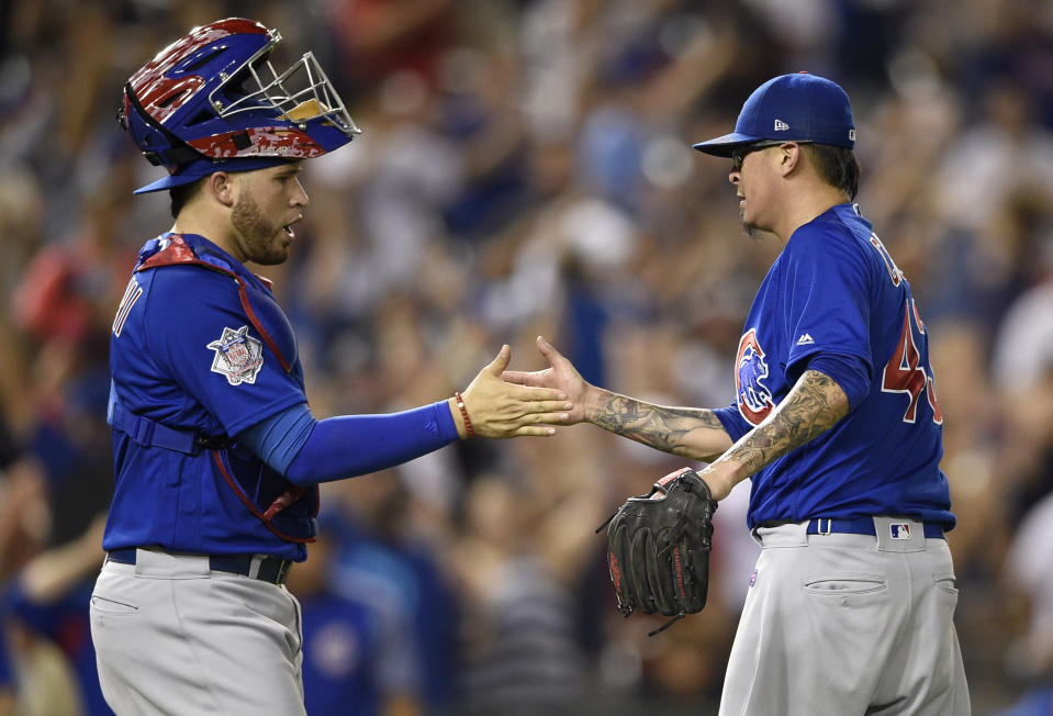 Chicago Cubs relief pitcher Jesse Chavez, right, celebrates with catcher Victor Caratini (7) after a baseball game against the Washington Nationals, Thursday, Sept. 6, 2018, in Washington. The Cubs won 6-4 in 10 innings. (AP Photo/Nick Wass)