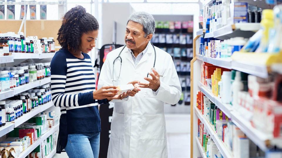 Shot of a pharmacist assisting a young woman in a chemist.