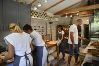 Eszter Roboz, bakery owner, makes pastries with her colleagues in Babushka Artisanal Bakery in Budapest, Hungary, Friday, Sept. 9, 2022. The gourmet bakery has raised its prices by 10% to keep up with rapidly rising costs of energy and raw materials, and taken steps to moderate its use of electricity to avoid having to close down. (AP Photo/Anna Szilagyi)