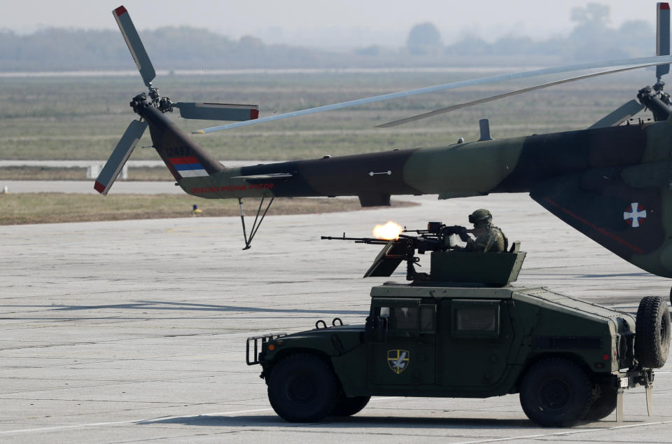 In this photo taken Saturday, Oct. 19, 2019, Serbian Army soldiers perform during a military parade at the military airport Batajnica, near Belgrade, Serbia. Citing alleged pressure from the West, Serbia has suspended all foreign military exercises Wednesday Sept. 9, 2020, ahead of the planned manoeuvres with Russia and Belarus. (AP Photo/Darko Vojinovic)