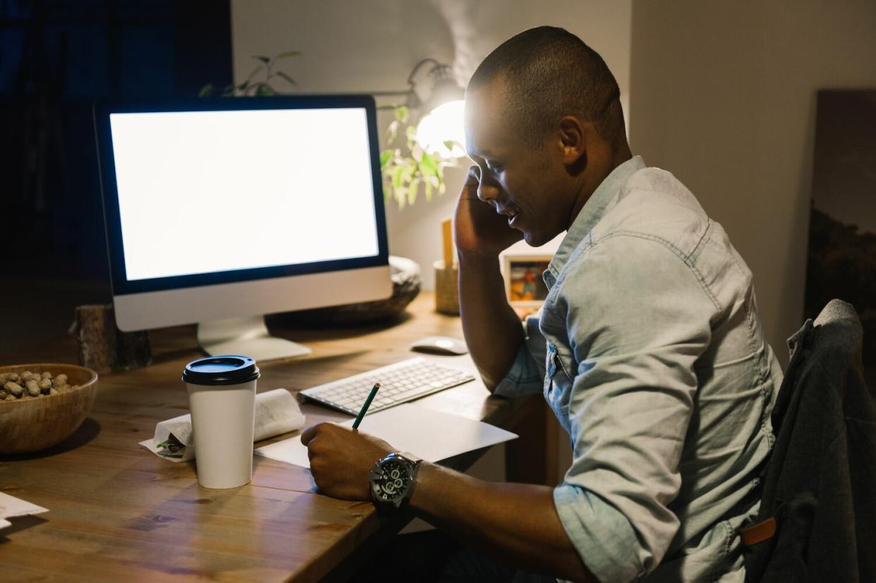 man on phone and computer