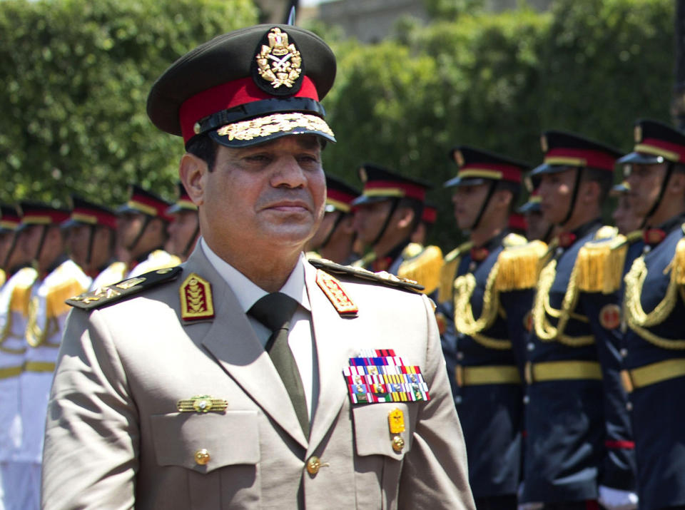 FILE - In this Wednesday, April 24, 2013 file photo, Egyptian Defense Minister Gen. Abdel-Fattah el-Sissi reviews honor guards during an arrival ceremony for his U.S. counterpart at the Ministry of Defense in Cairo. Egypt's military chief says he "can't turn his back" if the majority of Egyptians want him to run for president. El-Sissi's comments, made in a speech Tuesday, March 4, 2014 to military cadets and reported by the state news agency MEAN, are his strongest yet suggesting he intends to run. (AP Photo/Jim Watson, Pool, File)