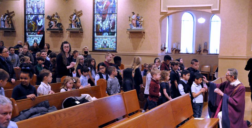 Father Stephen Moran leads an Ash Wednesday service at the St. Mary of the Immaculate Conception Church in Wooster.