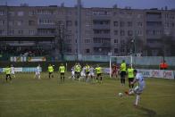 FILE In this photo taken on Saturday, March 28, 2020, Gorodeya's Milan Joksimovic, right back to camera, kicks the ball during the Belarus Championship soccer match between Gorodeya and Shakhter in the town of Gorodeya, Belarus. Longtime Belarus President Alexander Lukashenko refused to impose any restrictions, making Belarus the only country in Europe to continue playing professional soccer games with fans in the stands while the outbreak was in full swing. (AP Photo/Sergei Grits, File)