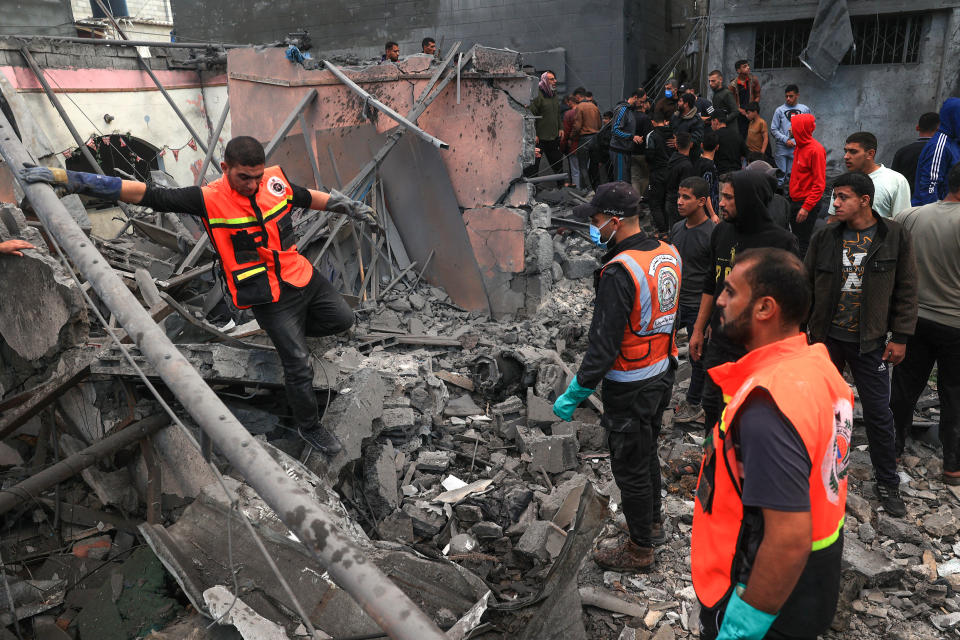 Palestinian medics search for survivors in the rubble of a building following Israeli bombardment in Rafah in the southern Gaza Strip on December 1, 2023, as fighting resumed shortly after the expiration of a seven-day truce between Israel and Hamas militants. A temporary truce between Israel and Hamas expired on December 1, with the Israeli army saying combat operations had resumed, accusing Hamas of violating the operational pause. (Photo by SAID KHATIB / AFP) (Photo by SAID KHATIB/AFP via Getty Images)