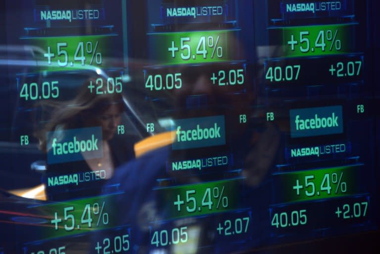 Screens display the start of trading in Facebook shares at the NASDAQ stock exchange on Times Square in New York, on May 18, 2012. Facebook is increasing its revenue from mobile with more users now accessing the social network via smartphones and tablets than from personal computers, but Wall Street remains unimpressed