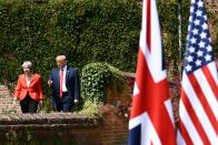 <p>President Donald Trump (R) and Britain’s Prime Minister Theresa May walk to hold a joint press conference following their meeting at Chequers, the prime minister’s country residence, near Ellesborough, northwest of London on July 13, 2018 on the second day of Trump’s U.K. visit. (Photo: Brendan Smialowski/AFP/Getty Images) </p>