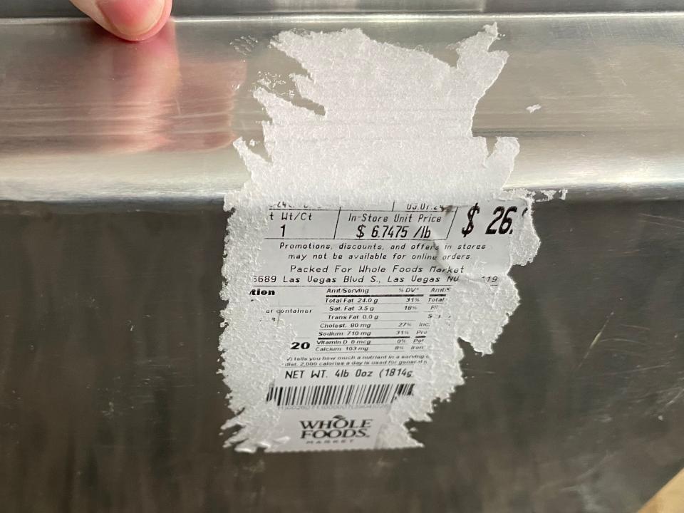 Partially ripped-up label on the side of an aluminum container for food