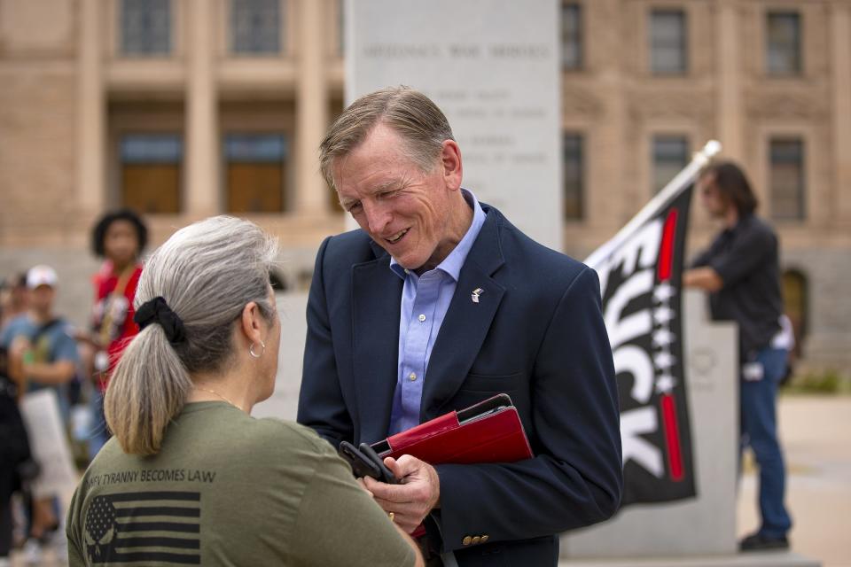 Rep. Paul Gosar speaks with a constituent on the Arizona State Capitol grounds in Phoenix on Sept. 24, 2021.