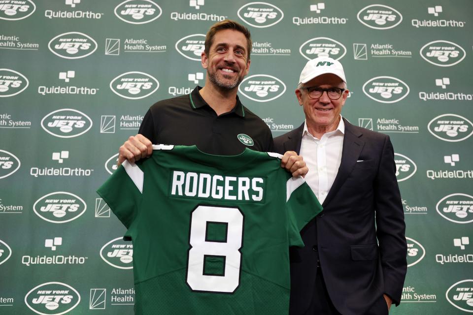 New York Jets quarterback Aaron Rodgers poses with team owner Woody Johnson during an introductory press conference at Atlantic Health Jets Training Center on April 26, 2023, in Florham Park, New Jersey.