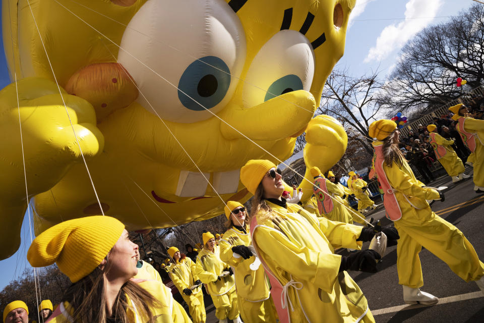 Balloon handlers hold SpongeBob Square Pants balloon close to the ground as strong winds affect the Macy's Thanksgiving Day Parade, Thursday, Nov. 28, 2019, in New York. (AP Photo/Mark Lennihan)