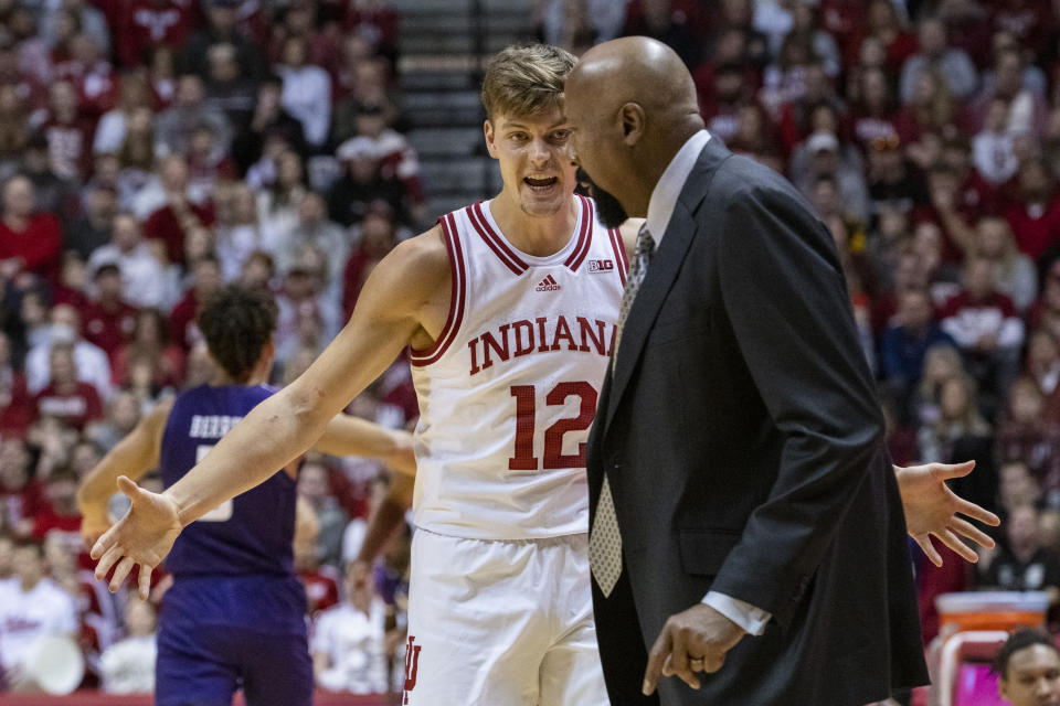 Indiana forward Miller Kopp (12) reacts toward head coach Mike Woodson during a break in the first half an NCAA college basketball game against Northwestern, Sunday, Jan. 8, 2023, in Bloomington, Ind. (AP Photo/Doug McSchooler)
