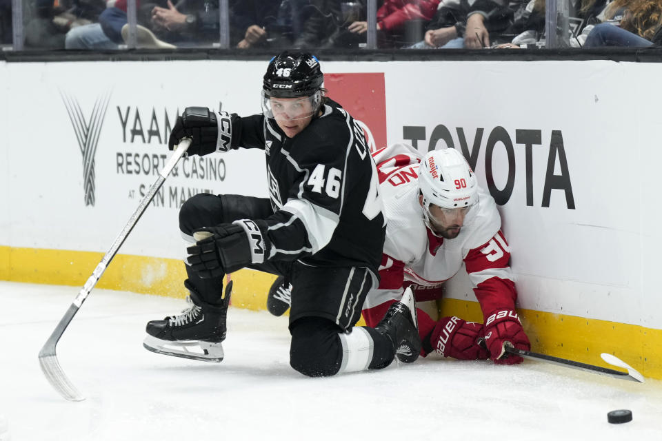 Los Angeles Kings center Blake Lizotte (46) and Detroit Red Wings center Joe Veleno fall to the ice while chasing the puck during the second period of an NHL hockey game Thursday, Jan. 4, 2024, in Los Angeles. (AP Photo/Jae C. Hong)