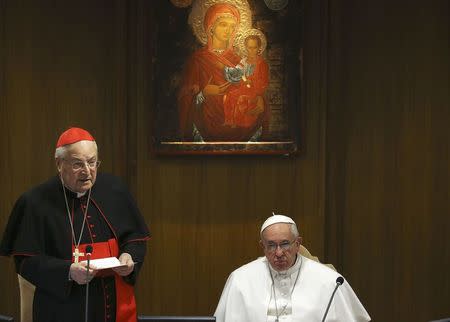 Pope Francis listens as Cardinal Angelo Sodano (L) speaks during a consistory where 20 new cardinals are named, at the Vatican February 12, 2015. REUTERS/Alessandro Bianchi