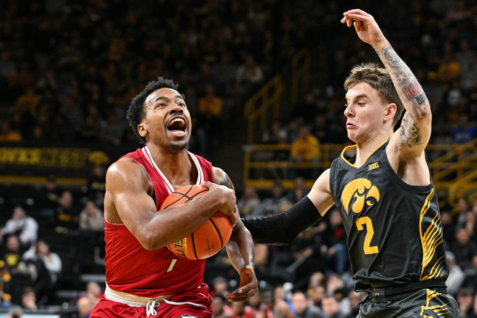 Then with Northern Illinois, guard David Coit (11) drives to the basket while Iowa guard Brock Harding (2) defends during the first half of a Dec. 29, 2023 game in Iowa City, Iowa.