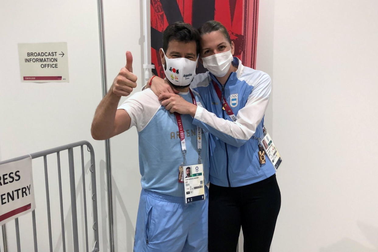 Argentine fencer Maria Belen Perez Maurice hugs her coach of 17 years, Lucas Guillermo Saucedo, after he proposed marriage to her on the sidelines of the Olympic fencing at Makuhari Messe Hall in Chiba, Japan July 26, 2021. Picture taken July 26, 2021. REUTERS/Sakura Murakami