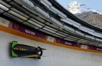 Jamaica's pilot Winston Watts (front) speeds down the track during a two-man bobsleigh training session at the Sanki Sliding Center in Rosa Khutor, a venue for the 2014 Sochi Winter Olympics near Sochi, February 14, 2014. REUTERS/Arnd Wiegmann (RUSSIA - Tags: SPORT BOBSLEIGH OLYMPICS)