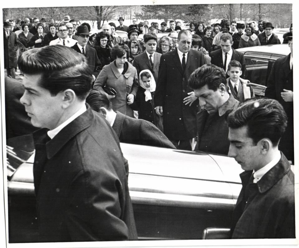 The family of Anthony Liuzzo (center, background) watches the casket of Viola Liuzzo, a civil rights activist who was killed in Alabama, on the day of her funeral in Detroit.