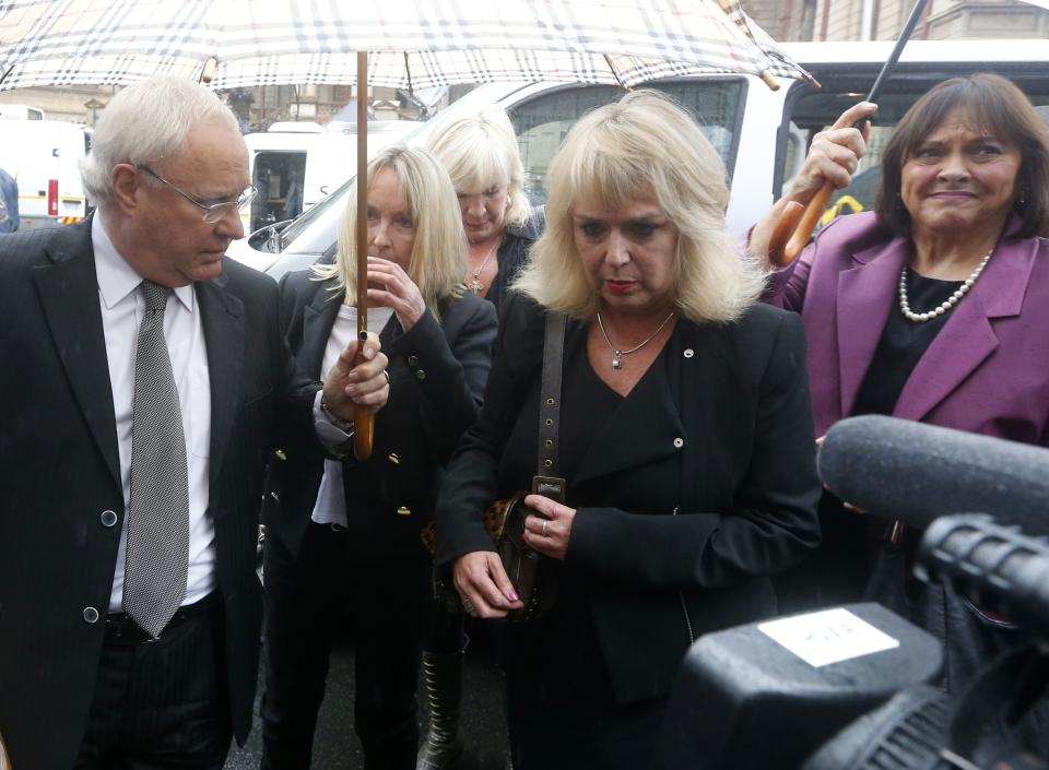 REFILE - CORRECTING POSITION OF JUNE STEENKAMP June Steenkamp (2nd L), mother of the murdered Reeva Steenkamp, arrives for the trial of Olympic and Paralympic track star Oscar Pistorius at the North Gauteng High Court in Pretoria March 3, 2014. Pistorius will stand in a Pretoria dock on Monday to face a charge of murdering his girlfriend Reeva, opening the decisive chapter in the story of the rise and fall of one of the world's most recognisable athletes. REUTERS/Mike Hutchings (SOUTH AFRICA - Tags: SPORT ATHLETICS CRIME LAW)