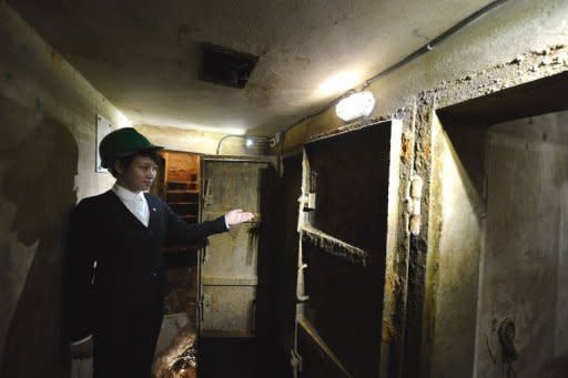 A Metropole Hotel employee guides a visitor to the hotel's war-time bomb shelter in Hanoi. Sealed off and forgotten after hostilities ended in 1975, the subterranean passages are now favoured by foreign tourists and wealthy Vietnamese