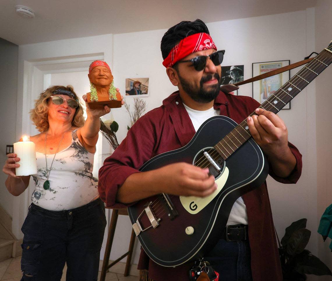 Rebecca Friedman and Enrique Rosell perform with the Willie Nelson Chia Pet, one of the items in the Dave Barry 2022 Holiday Gift Guide.