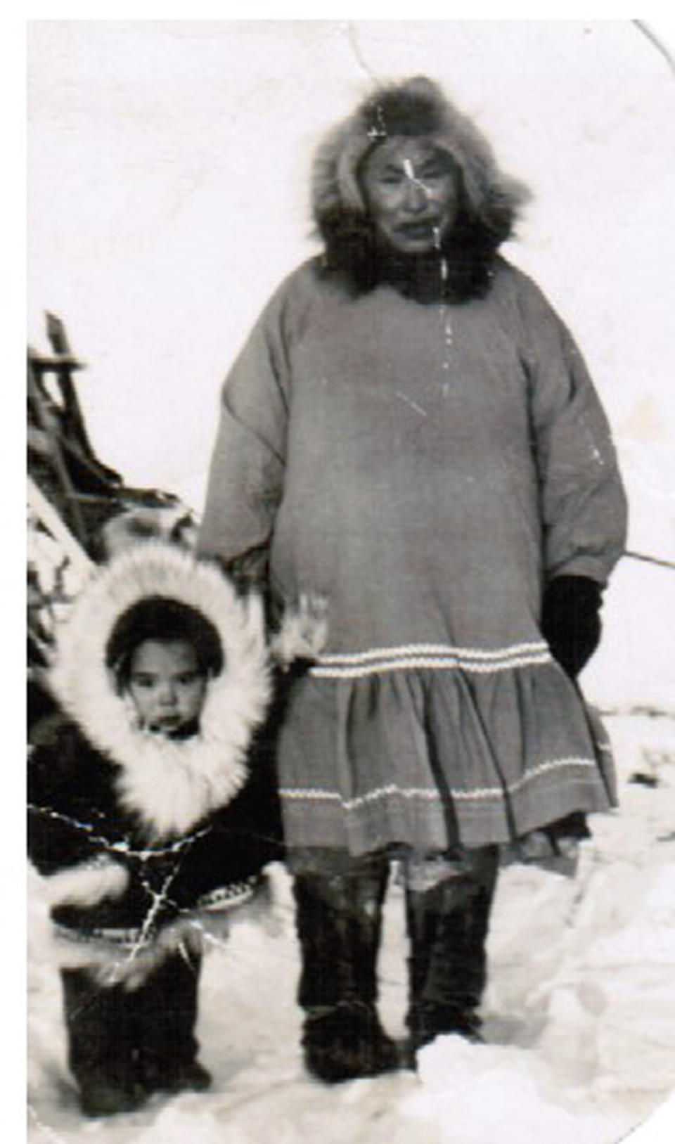 This undated photo shows a young Chris Kiana, left, with his grandmother in Selawik, Alaska. Kiana, who served in the Navy during the Vietnam War, is critical of a new government program that will allow Native veterans to apply for land that they might have missed out on in earlier programs because of their service. (Photo provided by Chris Kiana via AP)