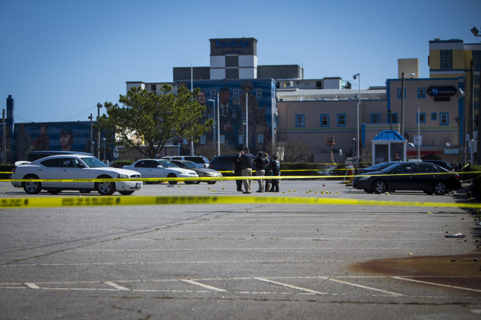 Virginia Beach police work the scene of a shooting the night before on Saturday, March 27, 2021 in Virginia Beach, Va. A pair of overnight fatal shootings along the beachfront in Virginia Beach wounded several people in a scene described by authorities on Saturday as “very chaotic.” (AP Photo/John C. Clark)