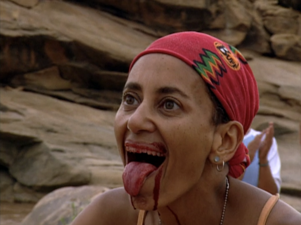 Linda Spencer sticks her tongue out with a mouth full of blood on Survivor: Africa