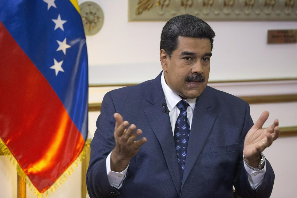 Venezuela's President Nicolas Maduro speaks during an interview with The Associated Press at Miraflores presidential palace in Caracas, Venezuela, Thursday, Feb. 14, 2019. Even while criticizing Donald Trump's confrontational stance toward his socialist government, Maduro said he holds out hope of meeting the U.S. president to resolve an impasse over his recognition of opponent Juan Guaido as Venezuela's rightful leader. (AP Photo/Ariana Cubillos)