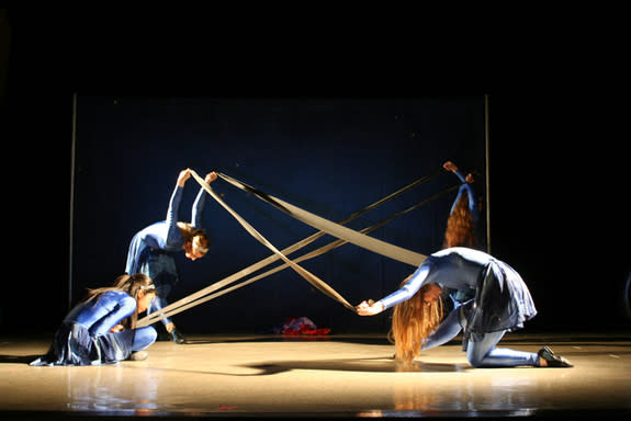 AstroDance dancers use stretch bands to represent the gravitational waves from supernovae.