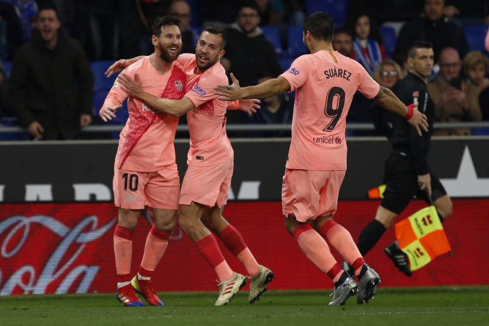 FC Barcelona's Lionel Messi, left, celebrates with teammates during the Spanish La Liga soccer match between Espanyol and FC Barcelona at RCDE stadium in Cornella Llobregat, Spain, Saturday, Dec. 8, 2018. (AP Photo/Joan Monfort5