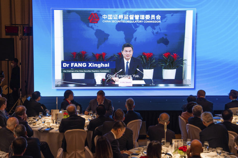 Vice Chairman of the China Securities Regulatory Commission Fang Xinghai speaks via video during the Global Financial Leaders' Investment Summit in Hong Kong, Wednesday, Nov. 2, 2022. Chinese regulators downplayed China's real estate slump and slowing economic growth while Hong Kong's top leader pitched Hong Kong as a unique link to the rest of China at a high-profile investment summit Wednesday. (AP Photo/Bertha Wang)