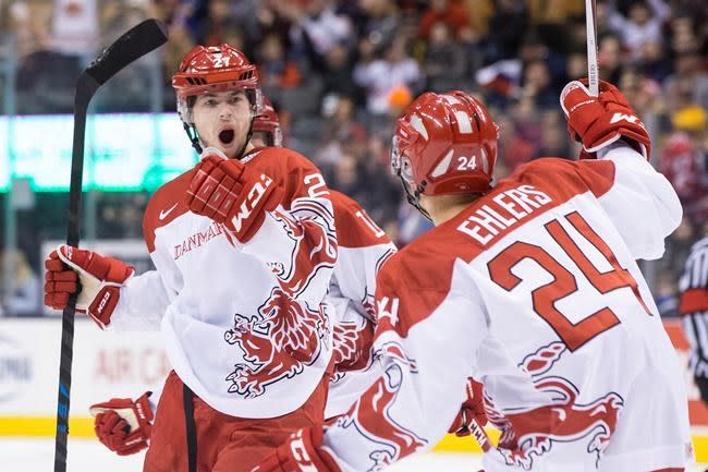 Denmark&#39;s Oliver Bjorkstrand, left, celebrates with Nikolaj Ehlers after scoring his team&#39;s opening goal against Russia during first period preliminary round action in the World Junior Hockey Championships in Toronto on Friday, December 26, 2014. THE CANADIAN PRESS/Chris Young