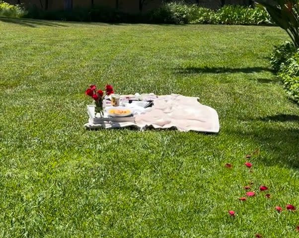 <p>Kourtney Kardashian/Instagram</p> The line of flower petals leading out to a picnic