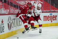 Carolina Hurricanes defenseman Brady Skjei (76) dumps Detroit Red Wings center Frans Nielsen (81) in the second period of an NHL hockey game Thursday, Jan. 14, 2021, in Detroit. (AP Photo/Paul Sancya)