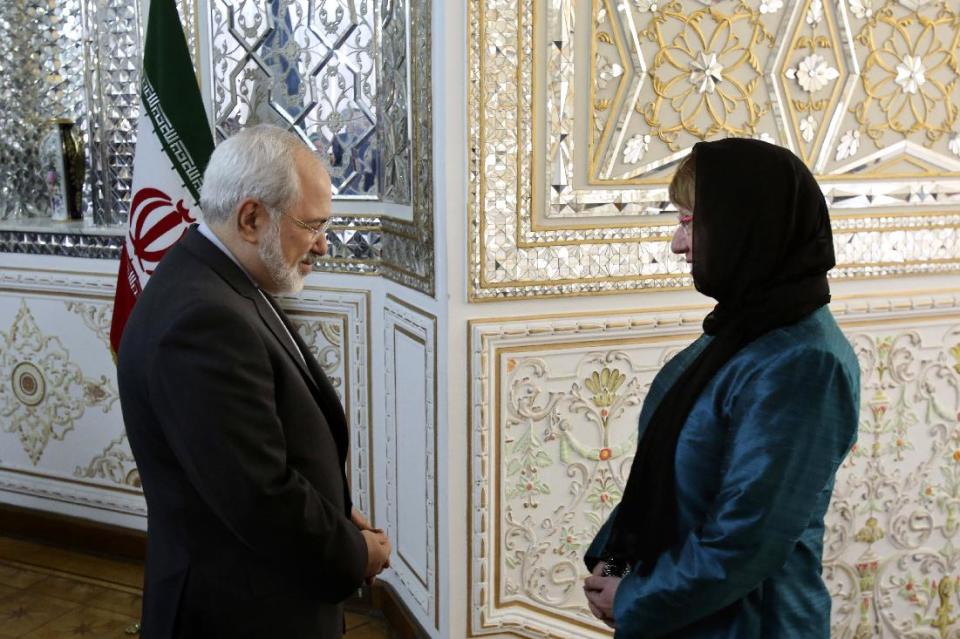 Iranian Foreign Minister Mohammad Javad Zarif, left, welcomes European Union's foreign policy chief Catherine Ashton for their meeting, in Tehran, Iran, Sunday, March 9, 2014. Ashton is saying there is no guarantee for a successful final nuclear deal with Iran. (AP Photo/Vahid Salemi)
