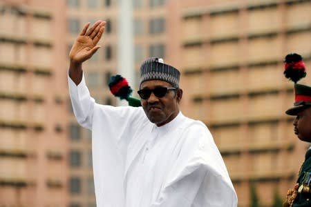 FILE PHOTO: Nigerian President Muhammadu Buhari waves at the crowd while he drives around the venue during his inauguration for a second term in Abuja