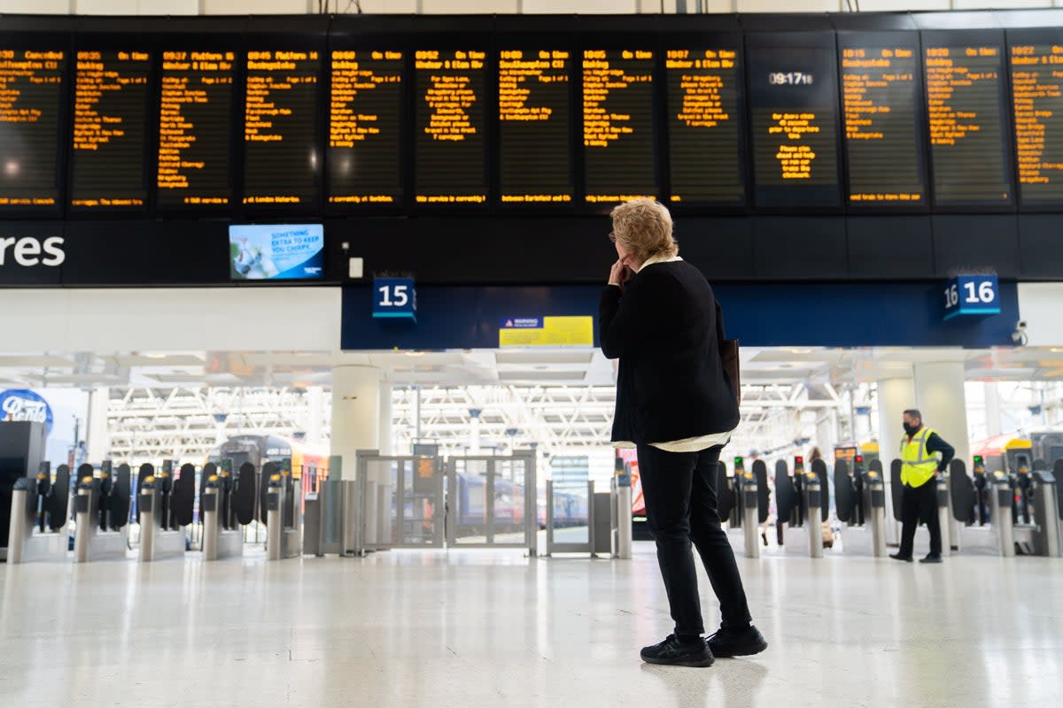 A passenger at Waterloo train station in London (James Manning/PA) (PA Wire)