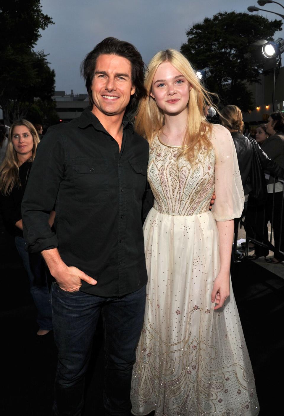 Actors Tom Cruise (L) and Elle Fanning arrive at the "Super 8" Los Angeles Premiere held at Regency Village Theatre on June 8, 2011 in Westwood, California.