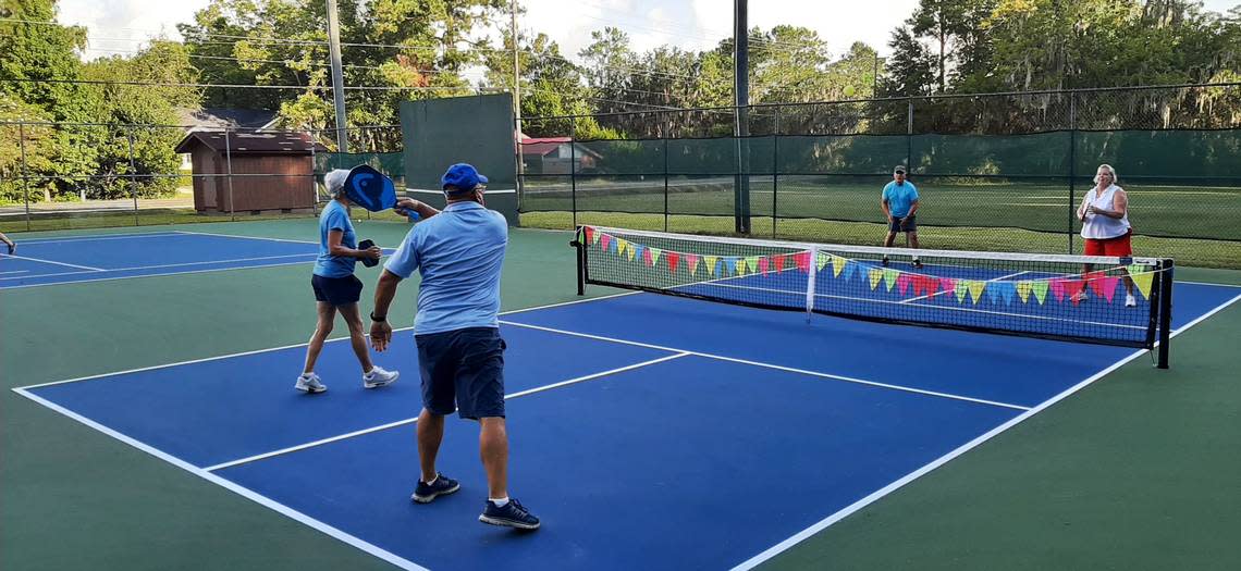 Bob Mullins whacks the ball during a pickleball game on a new pickleball court at Southside Park in Beaufort Wednesday morning. Mullins and his wife, across the net, to the right, are still learning the game, which they are learning to love. “Anybody and everybody can play,” Gail says.