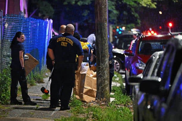 Police place a rifle in a bag on the scene of a shooting on 3 July 2023 in Philadelphia, Pennsylvania (Getty Images)