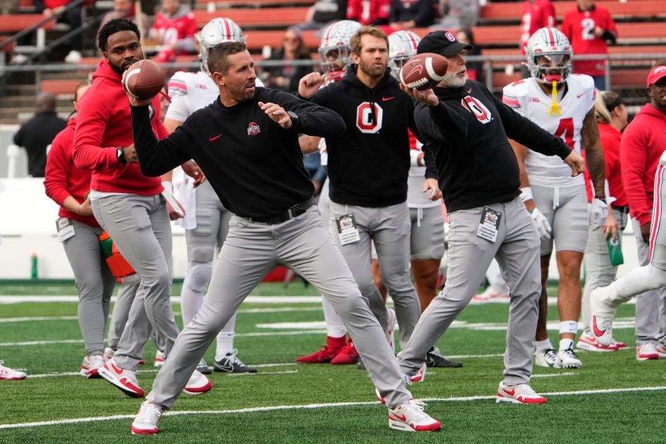 Nov 4, 2023; Piscataway, New Jersey, USA; Ohio State Buckeyes offensive coordinator Brian Hartline and defensive coordinator Jim Knowles warm up players during the NCAA football game against the Rutgers Scarlet Knights at SHI Stadium. Ohio State won 35-16.