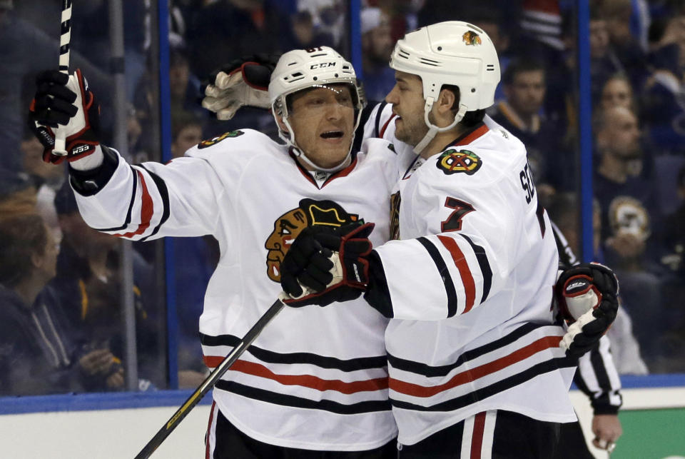 Chicago Blackhawks' Brent Seabrook, right, is congratulated by Marian Hossa, of Slovakia, after scoring during the first period in Game 1 of a first-round NHL hockey Stanley Cup playoff series against the St. Louis Blues on Thursday, April 17, 2014, in St. Louis. (AP Photo/Jeff Roberson)