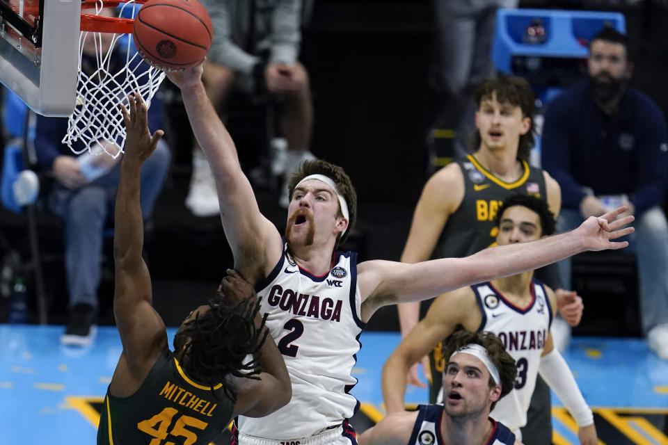 FILE - Gonzaga forward Drew Timme (2) blocks a shot by Baylor guard Davion Mitchell (45) during the first half of the championship game in the men's Final Four NCAA college basketball tournament in Indianapolis, in this Monday, April 5, 2021, file photo. The Zags lost major pieces from the that team that reached the final undefeated before losing to Baylor. But Gonzaga has reloaded with a group of talented freshmen that combined with holdovers like Drew Timme and Andrew Nembhard might make the Zags even better than a season ago. (AP Photo/Michael Conroy, File)