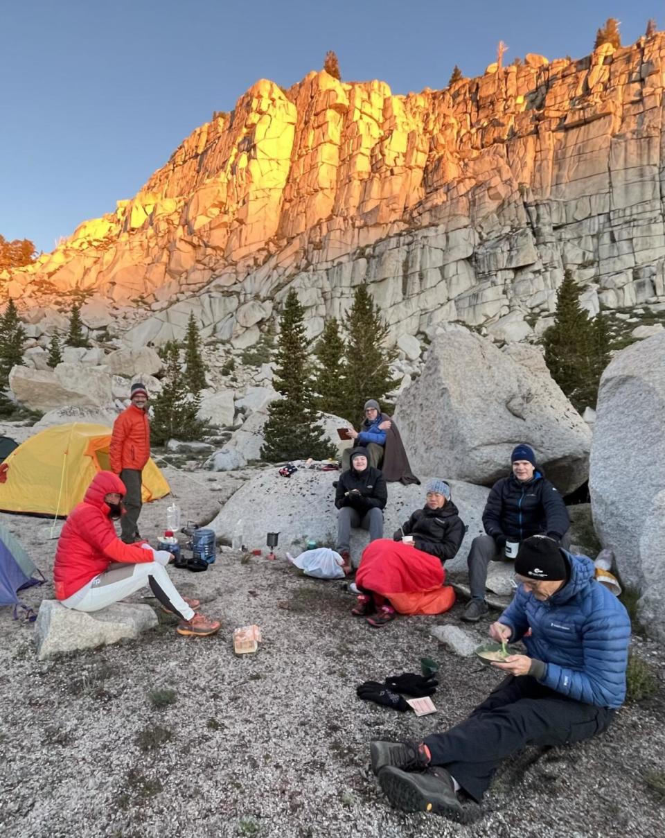 Eline Øidvin, third from right, joins her guides for a sunrise breakfast at 11,000 feet at their base camp.