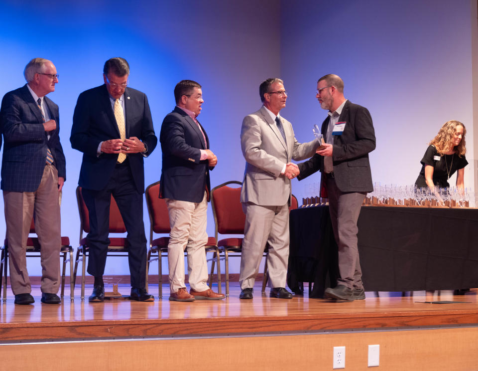 Shane Hepler, chief information officer for Amarillo College, accepts his award Thursday at the Texans Caring for Texans ceremony at West Texas A&M University in Canyon.