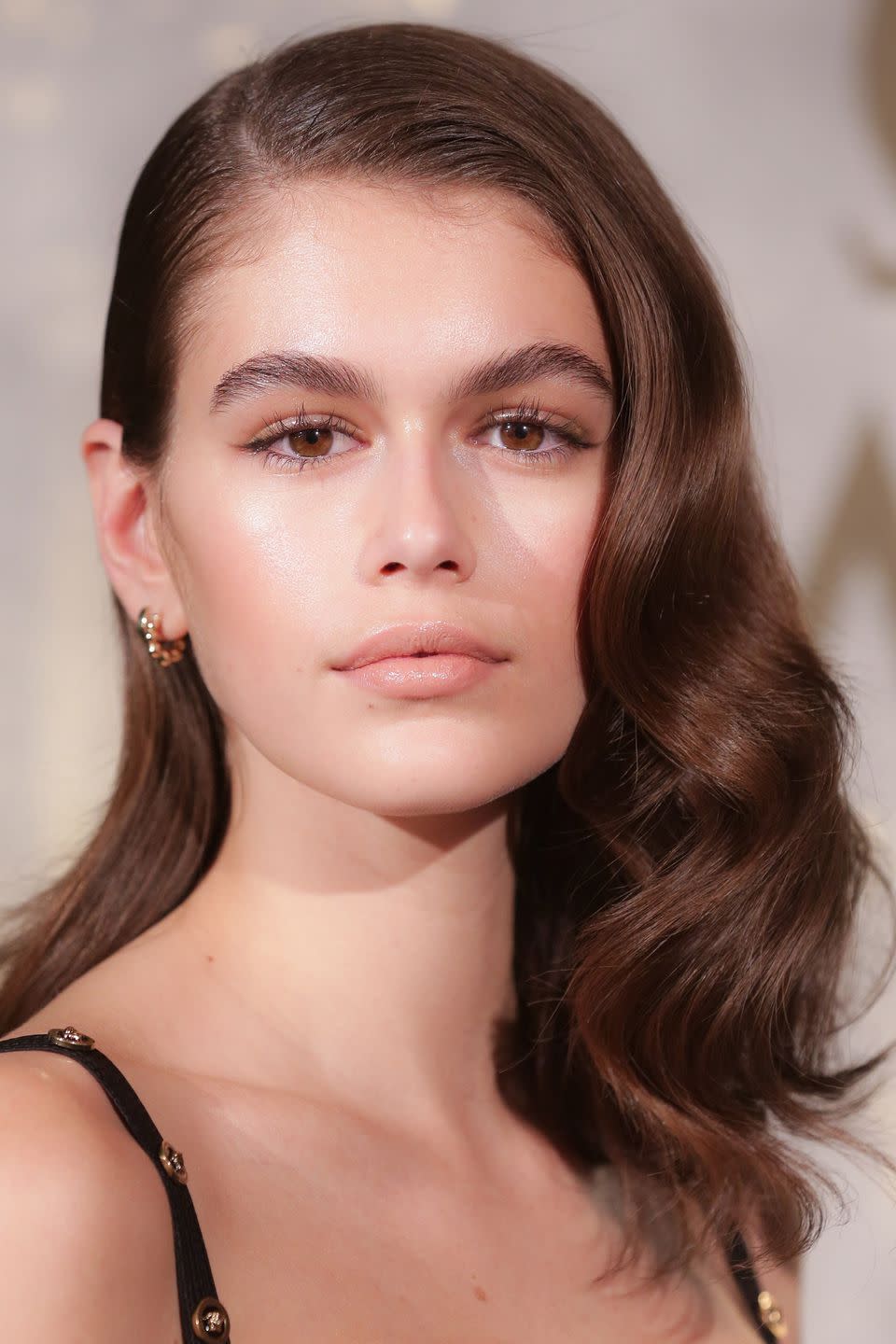 <p>Kaia Gerber's looked every inch the supermodel in Berlin yesterday, and the trick to recreating her flawless beauty look is to focus on subtly defining your eyes. Copy the model's brushed-up brows with Glossier's <a rel="nofollow noopener" href="https://www.glossier.com/products/boy-brow?locale=en-GB&gclid=Cj0KCQjw5qrXBRC3ARIsAJq3bwpKKNu6cCjKpRcAOkVhk-bTLMvwyE75x2HP7Bu4kbAdjbIWCvtzwOsaApbdEALw_wcB" target="_blank" data-ylk="slk:Boy Brows;elm:context_link;itc:0;sec:content-canvas" class="link ">Boy Brows</a>, £14, and use lengthening mascara and small eyeliner flicks - try Dior's <a rel="nofollow noopener" href="https://www.dior.com/beauty/en_gb/fragrance-beauty/makeup/eyes/liners/pr-liners-y0775101_f077510098-precision-eyeliner.html?LGWCODE=F077510098GB;143909;6271&gclid=Cj0KCQjw5qrXBRC3ARIsAJq3bwpTXIEtZ-ogiWO5jShZfXNBV36Qgo-ezLKMH-3nU8VJu8b4GMQMItMaAm32EALw_wcB" target="_blank" data-ylk="slk:Precision Liner;elm:context_link;itc:0;sec:content-canvas" class="link ">Precision Liner</a>, £27 - in place of heavy eyeliner. Then, style your hair into soft waves, using L'Oreal Professionnel's <a rel="nofollow noopener" href="https://www.mankind.co.uk/l-oreal-professionnel-tecni-art-pli-shaper-190ml/10897276.html?affil=thgppc&utm_source=criteo&utm_medium=cpc&utm_campaign=DynamicRemarketingCriteo&switchcurrency=GBP&shippingcountry=GB" target="_blank" data-ylk="slk:Techni Art Pli;elm:context_link;itc:0;sec:content-canvas" class="link ">Techni Art Pli</a>, £11.50, to slick-down a side-parting and GHD's <a rel="nofollow noopener" href="https://www.ghdhair.com/tongs/ghd-curve-soft-curl-tong?CMP=EMC-555&PLA=302&CRE=BRAND&TYPE=sponsoredsearch&gclid=Cj0KCQjw5qrXBRC3ARIsAJq3bwqIHoBmNF5iByV4kuZhHGhSRzYebRxDAESfe4cN00j55iGviF8acoMaAuPrEALw_wcB&gclsrc=aw.ds" target="_blank" data-ylk="slk:Curve Soft Curl Tong;elm:context_link;itc:0;sec:content-canvas" class="link ">Curve Soft Curl Tong</a>, £120, to create the curls.</p>