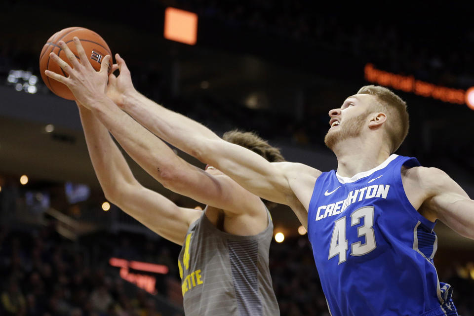 Creighton's Kelvin Jones (43) and Marquette's Jayce Johnson reach for a rebound during the first half of an NCAA college basketball game Tuesday, Feb. 18, 2020, in Milwaukee. (AP Photo/Aaron Gash)