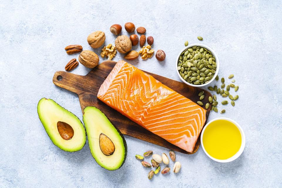 healthy eating for well balanced diet and heart care overhead view of a group of food rich in healthy fats the composition includes salmon, avocado, extra virgin olive oil, nuts and seeds like walnut, almonds, pecan, hazelnuts, pistachio and pumpkin seeds high resolution 42mp studio digital capture taken with sony a7rii and zeiss batis 40mm f20 cf lens