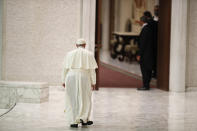 Pope Francis leaves at the end of his weekly general audience in the Paul VI Hall at the Vatican, Wednesday, Oct. 28, 2020. Pope Francis has blamed “this lady COVID” for forcing him to keep his distance from the faithful during his general audience, which was far smaller than usual amid soaring coronavirus infections in Italy. (AP Photo/Alessandra Tarantino)